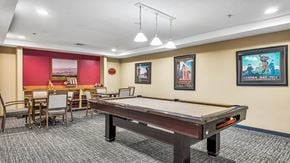 Ellicott City apartment for rent - A room with a pool table and a dining table.