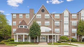 Ellicott City apartment for rent - A large apartment complex with a gazebo-like structure in the front.