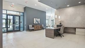 Washington apartment for rent - A modern office space with a reception desk and a chair.
