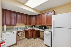 Columbia apartment for rent - a kitchen with white appliances and wooden cabinets