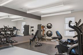 Baltimore apartment for rent - A gym with a variety of equipment including weights and machines.