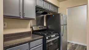 Washington apartment for rent - A kitchen with a black stove and refrigerator.