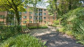 Annapolis apartment for rent - A park area with a bench and a building in the background.