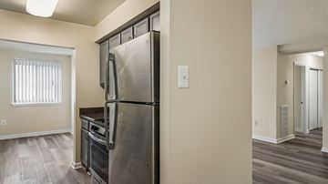 Washington apartment for rent - A kitchen with a stainless steel refrigerator and oven.