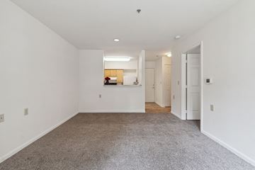 Columbia apartment for rent - a living room with carpet and white walls and a kitchen