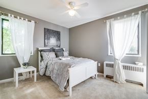 Washington apartment for rent - Comfortable bedroom with generous space, bright windows, and neutral tones at Meadowbrook Run, ideal for creating a restful personal retreat in Southeast Washington, D.C.
