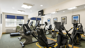 Elkridge apartment for rent - A gym with treadmills, exercise bikes, and elliptical machines.