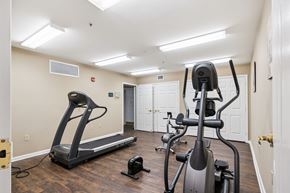 Baltimore apartment for rent - A home gym with a treadmill, elliptical trainer and a stationary bike.