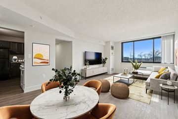 Washington apartment for rent - A living room with a white marble table and orange chairs.