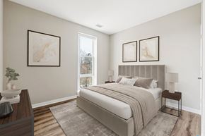 Silver Spring apartment for rent - A bedroom with a large bed and two framed pictures on the wall.