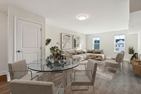 La Plata apartment for rent - A modern dining room with a glass table and chairs.