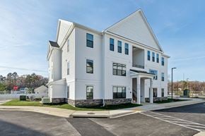 La Plata apartment for rent - A white building with a parking lot in front.