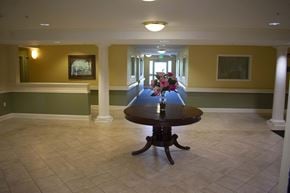Middle River apartment for rent - A vast hallway with a display table and colorful flowers