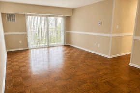 Washington apartment for rent - A room with wooden flooring and a sliding glass door.