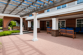 York apartment for rent - A covered walkway with benches and pillars.