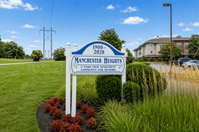 York apartment for rent - A sign for Manchester Heights Apartments stands in front of a grassy area.
