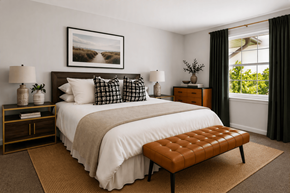 Elkridge apartment for rent - A bedroom with a large bed and a bench in front of it.