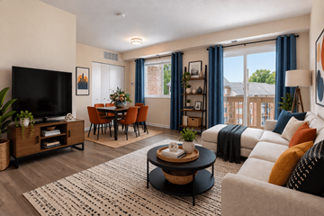 Washington apartment for rent - A living room with a flat screen TV, a coffee table, and a couch with throw pillows.
