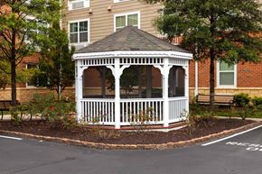 Severna Park apartment for rent - a white gazebo in a garden area in front of a house
