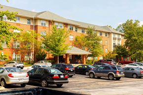 Elkridge apartment for rent - Exterior view of Park View at Colonial Landing, an award-winning senior apartment community in Elkridge, Maryland, surrounded by trees and featuring easy access to Route 1 and public transportation.