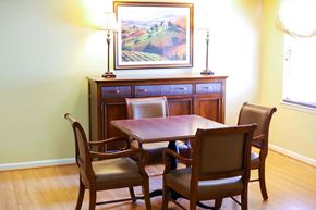 Rosedale apartment for rent - A community room table with four chairs and a painting on the wall.