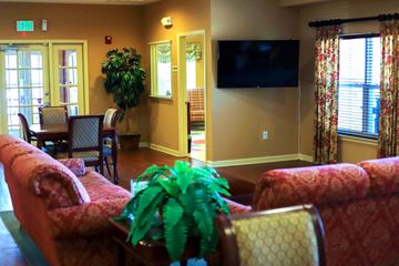 Edgewood apartment for rent - a living room with couches and a table with a television