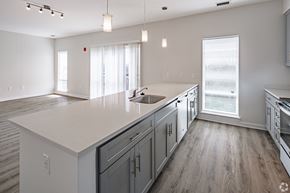 Columbia apartment for rent - an open kitchen and living room with white countertops and a large white counter top
