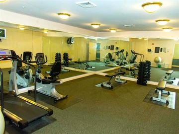 Dundalk apartment for rent - a gym with weights and mirrors on the floor and a pool