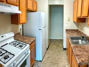 Frederick apartment for rent - a kitchen with a stove and refrigerator and a sink