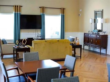 Princess Anne apartment for rent - a living room with a couch and a table and chairs