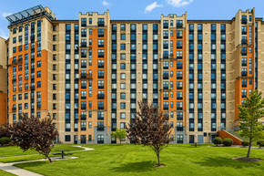 Washington apartment for rent - A large building with a green lawn in front.