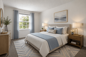 Ellicott City apartment for rent - A bedroom with a large bed and a window with curtains.