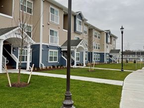 Princess Anne apartment for rent - a row of blue and white houses on a sidewalk