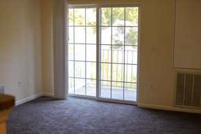 Princess Anne apartment for rent - A room with a sliding glass door leading to a backyard.