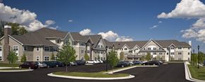 Catonsville apartment for rent - A large building with a parking lot in front.