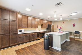 Baltimore apartment for rent - A kitchen with wooden cabinets and a white counter.