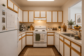 Baltimore apartment for rent - A kitchen with white appliances and wooden cabinets.