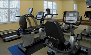Brooklyn Park apartment for rent - a room with a row of exercise bikes in front of a window