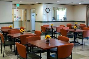 Easton apartment for rent - a dining room with tables and chairs and a clock on the wall
