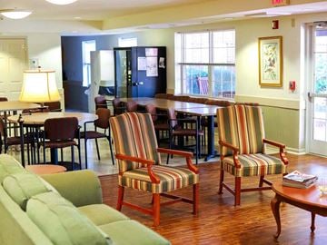 York apartment for rent - a living room filled with furniture and a table and chairs