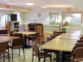 York apartment for rent - a dining room with tables and chairs and a piano