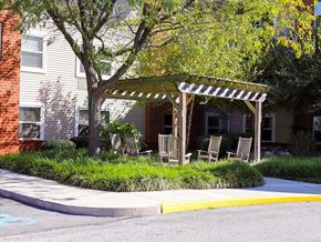 York apartment for rent - a group of chairs sitting under a wooden canopy