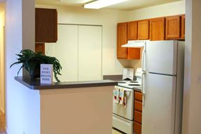 Red Lion apartment for rent - a kitchen with white appliances and a counter with a sign on it