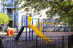 Red Lion apartment for rent - a playground with a yellow slide in front of a building