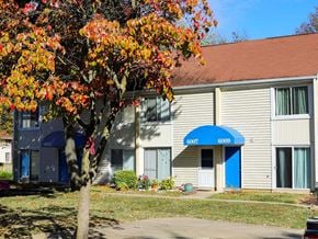 Columbia apartment for rent - A tree with orange leaves is in front of a building with the number 6009 on it.