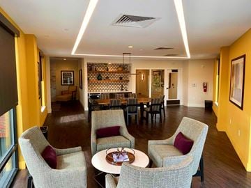 Baltimore apartment for rent - a large living room with a table and chairs