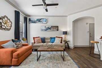Round Rock apartment for rent - A living room with a sofa, a coffee table, and a painting on the wall.
