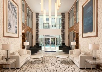 Lake Mary apartment for rent - A large, modern living room with a white sofa set and a patterned rug.