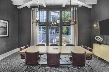 A conference room with a long table and chairs