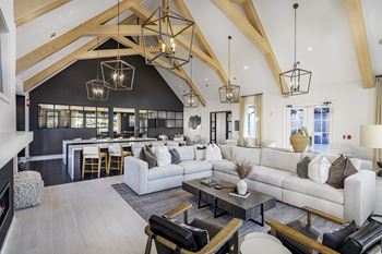 A modern living room with a high ceiling and wooden beams